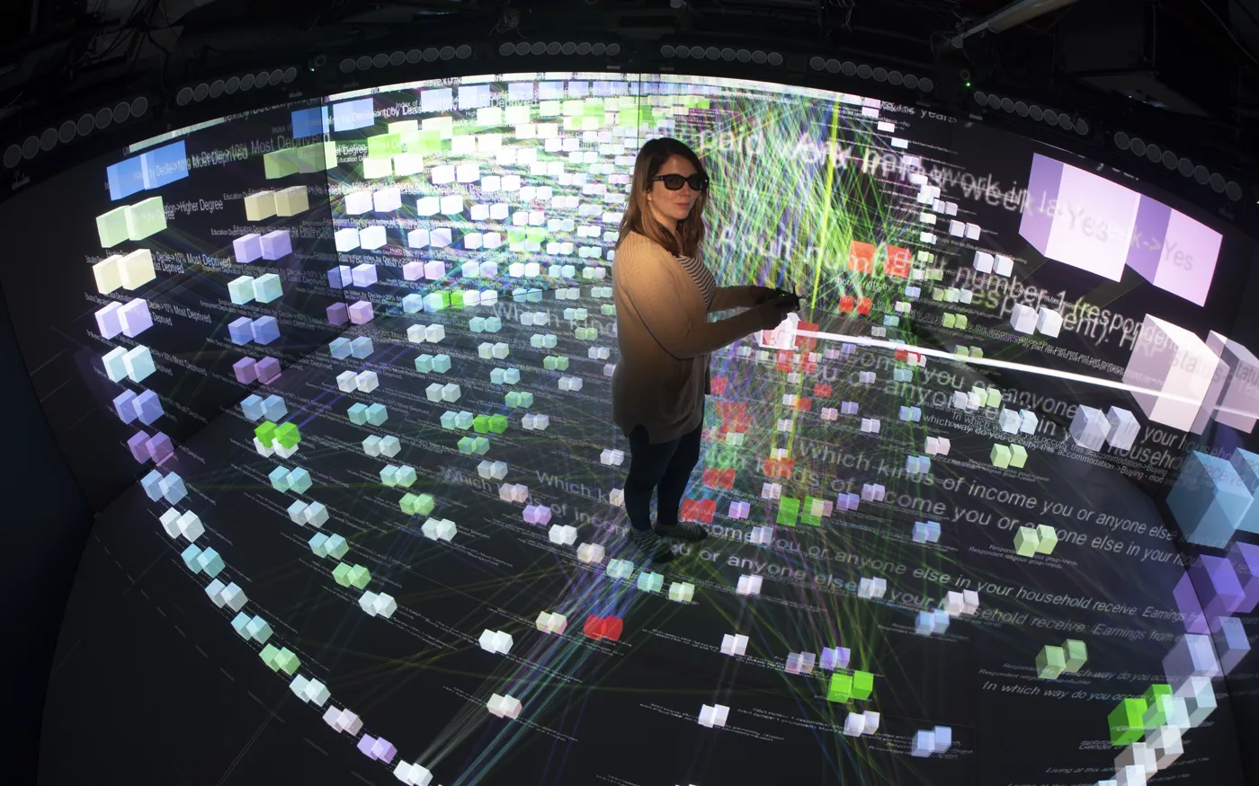Researcher in stereoscopic CAVE exploring a 3D knowledge graph with node and edge structures projected at room scale