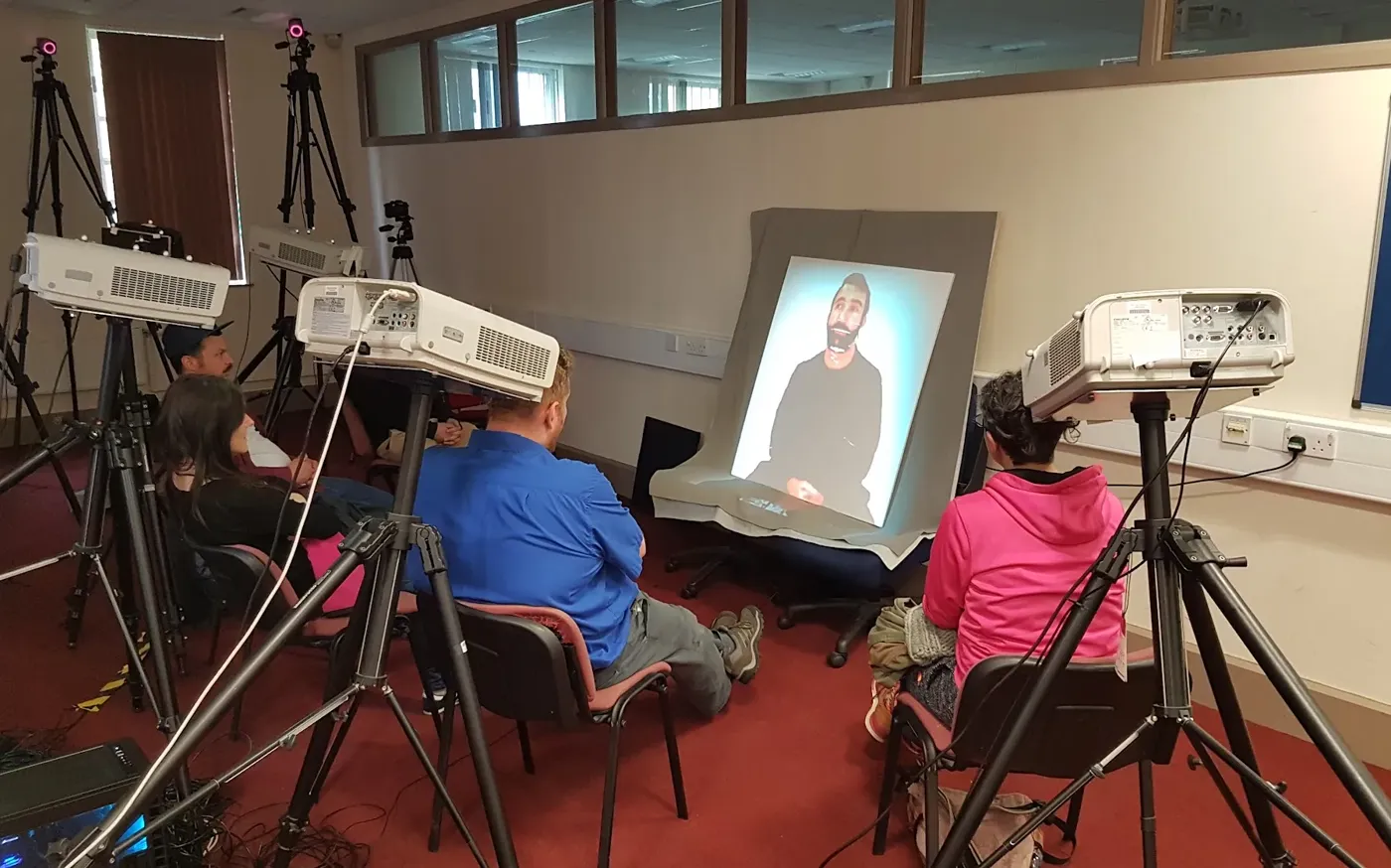 Telepresence session with remote participant projected life-size in studio environment